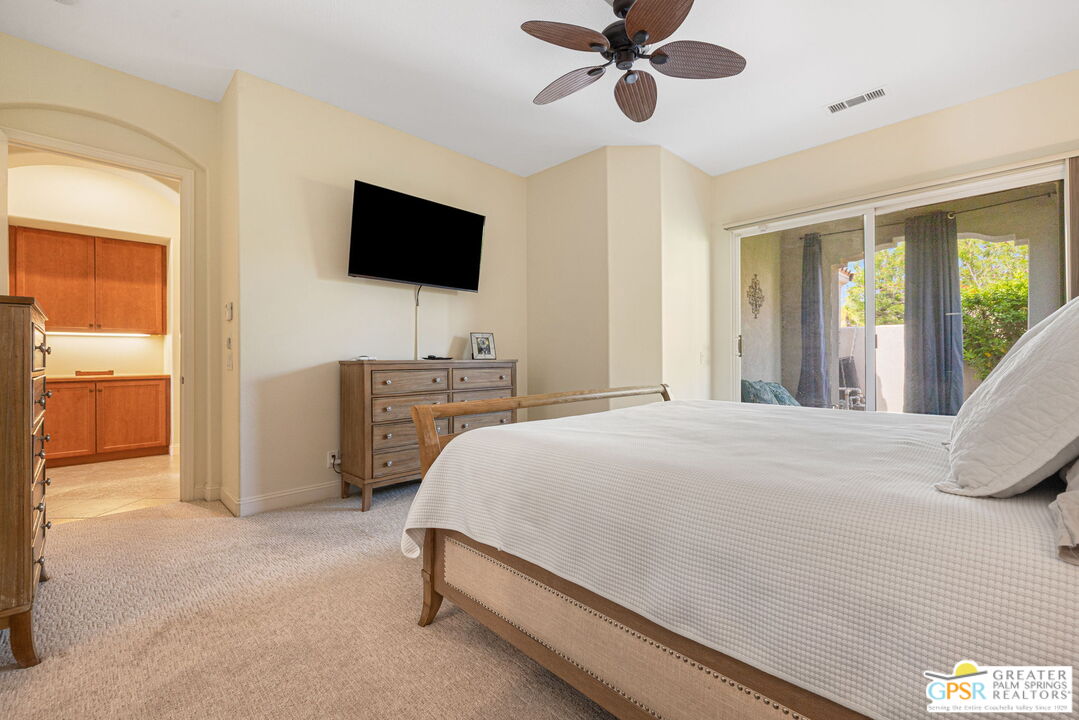 88 Vía Las Flores Rancho Mirage, CA 92270 - Photo 48 of 65 a bedroom with a bed and a flat screen tv