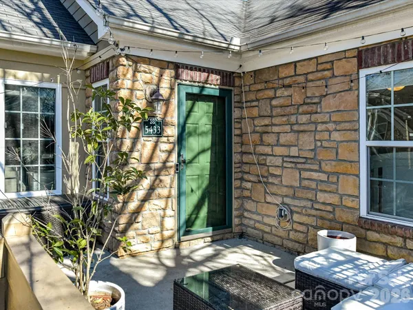 a backyard of a house with outdoor seating