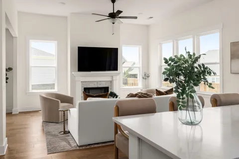 a living room with furniture a fireplace and flat screen tv