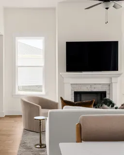 a living room with fireplace furniture and a flat screen tv