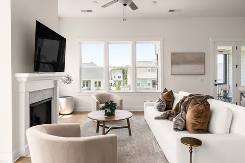 a living room with furniture and a fireplace