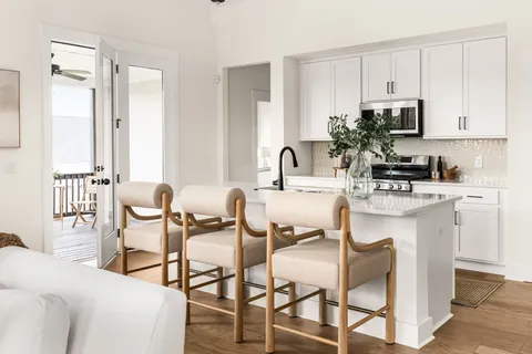 a kitchen with kitchen island a sink appliances and cabinets