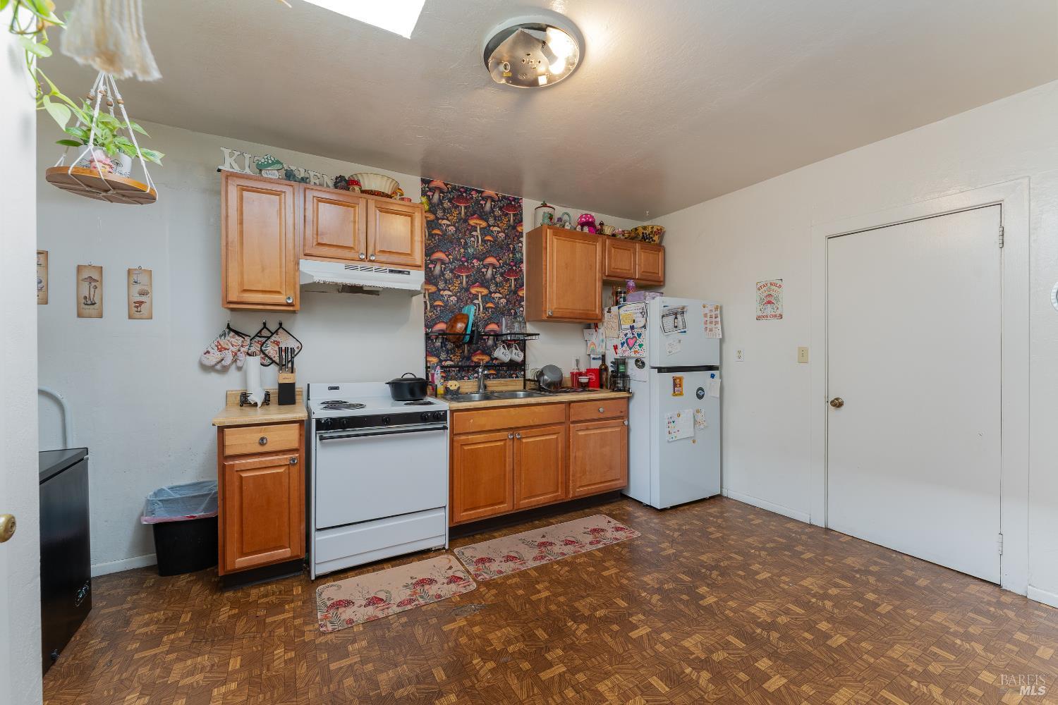 38 South Main Street Willits, CA 95490 - Photo 30 of 88 a kitchen with stainless steel appliances a stove a sink and a refrigerator