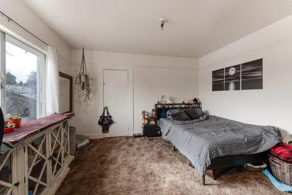 a bedroom with bed and window