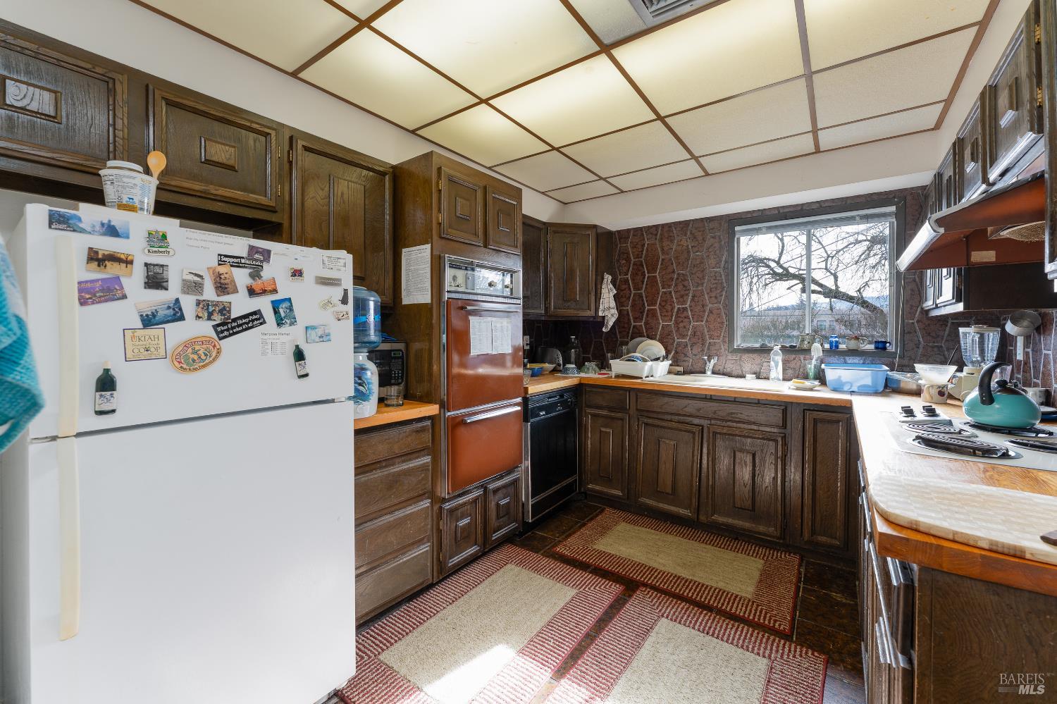 38 South Main Street Willits, CA 95490 - Photo 59 of 88 a kitchen with stainless steel appliances granite countertop a refrigerator and a stove top oven