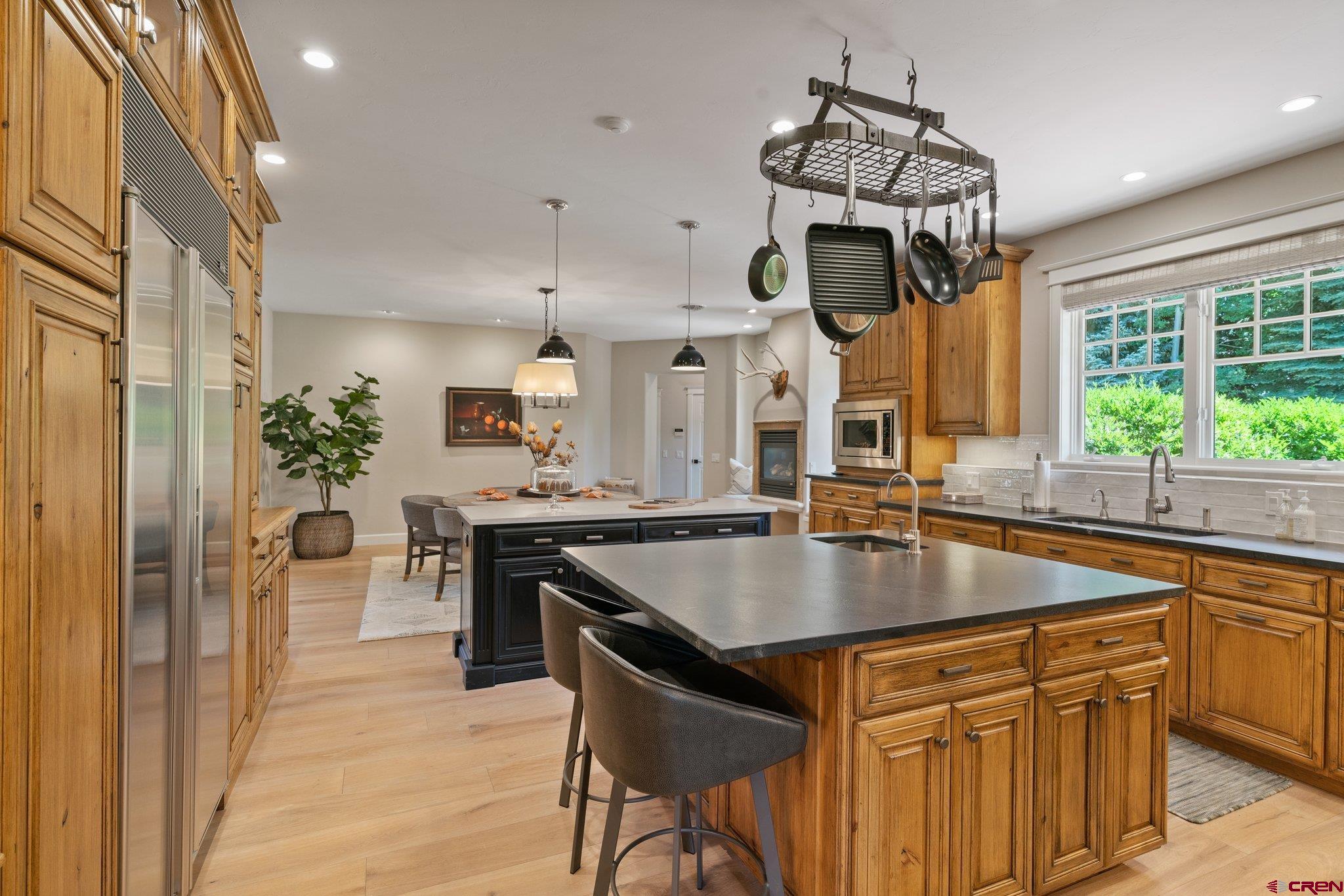 385 Red Rock Road Durango, CO 81301 - Photo 17 of 35 a kitchen with a table chairs sink and cabinets