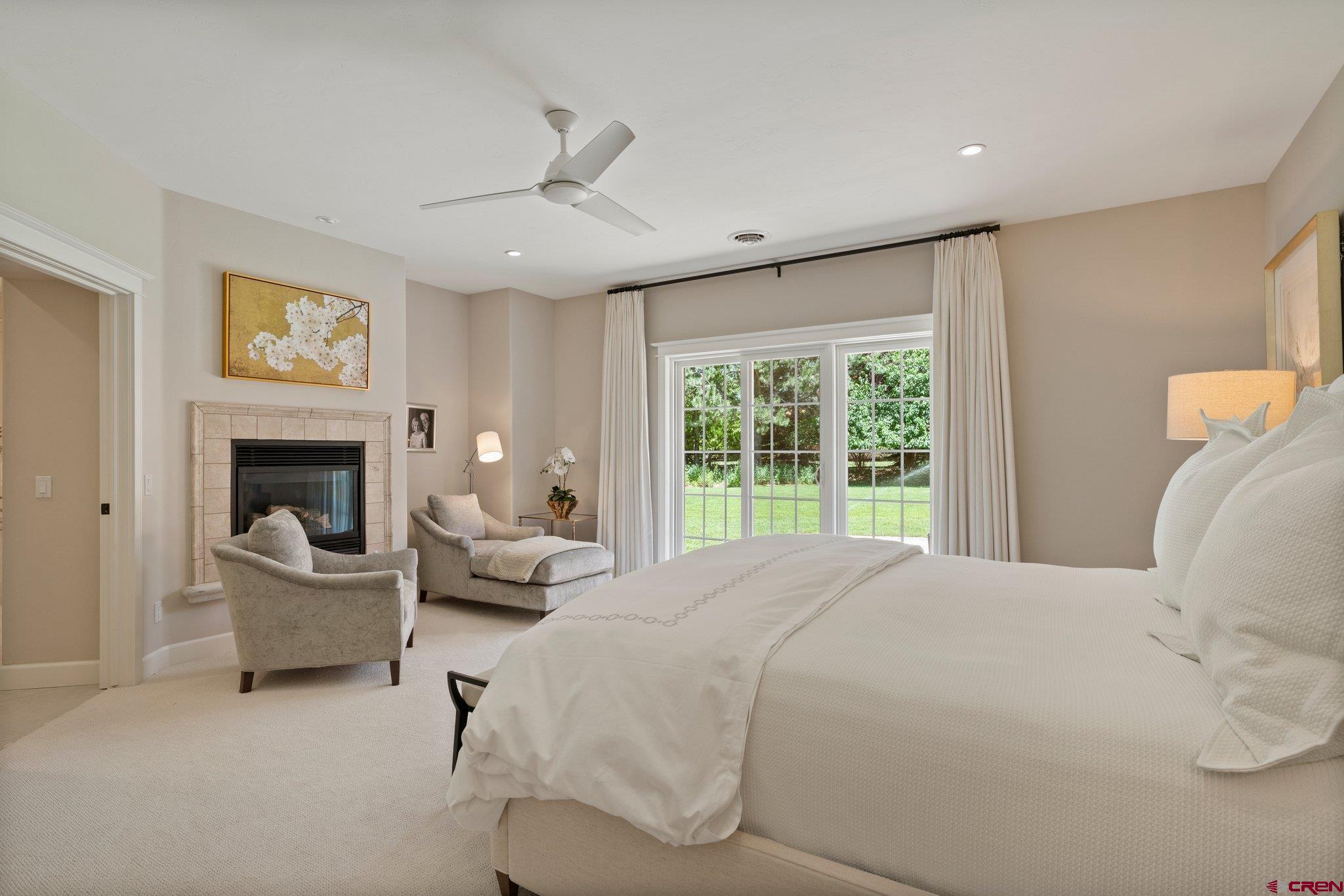 385 Red Rock Road Durango, CO 81301 - Photo 23 of 35 a bedroom with a bed and a fireplace