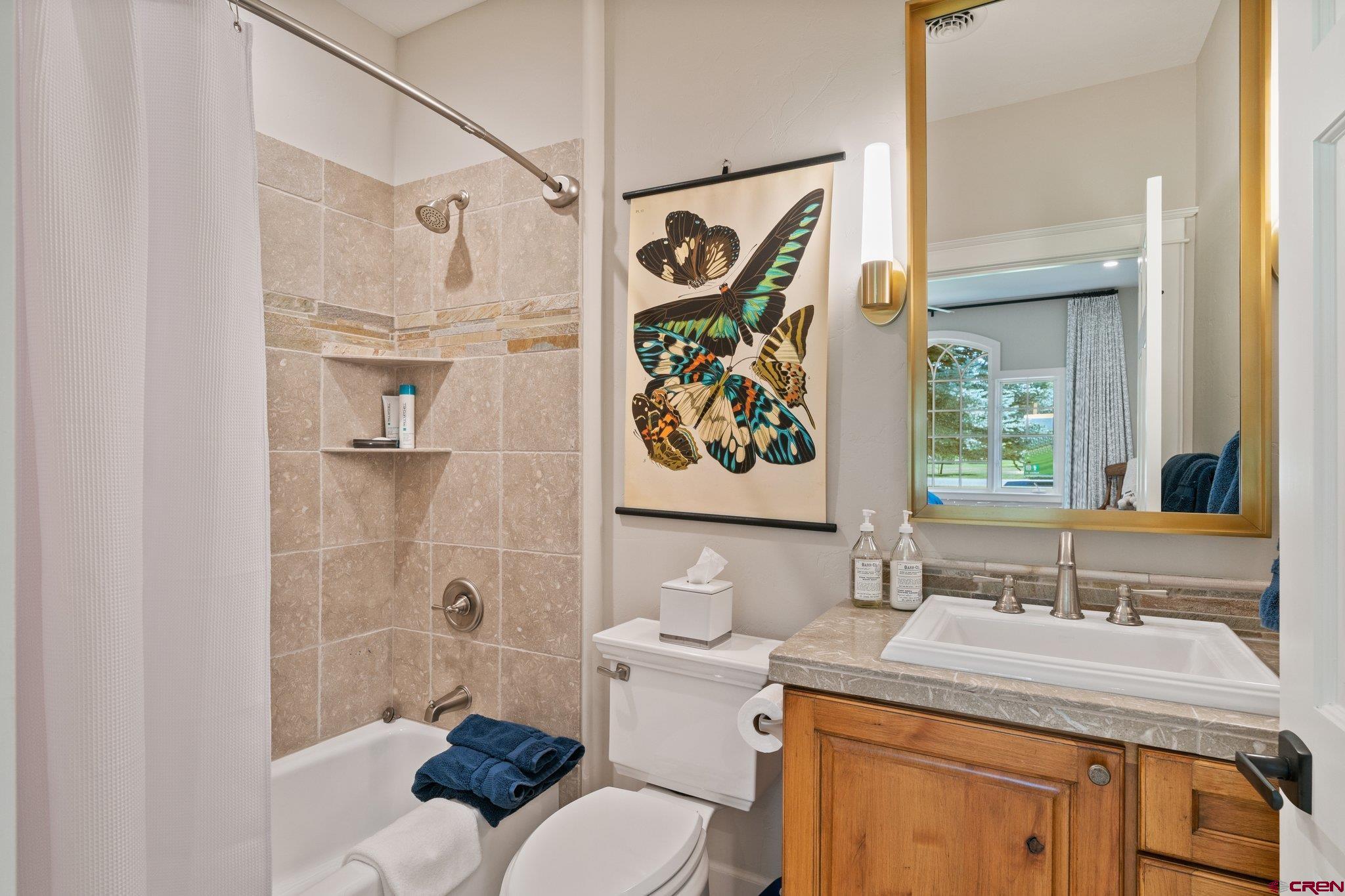 385 Red Rock Road Durango, CO 81301 - Photo 28 of 35 a bathroom with a granite countertop sink a toilet and shower