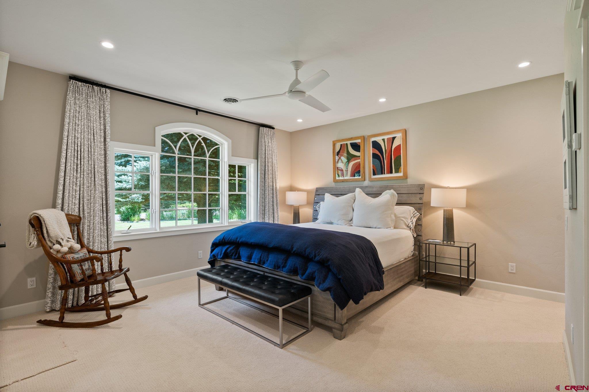 385 Red Rock Road Durango, CO 81301 - Photo 30 of 35 a spacious bedroom with a bed and glass window