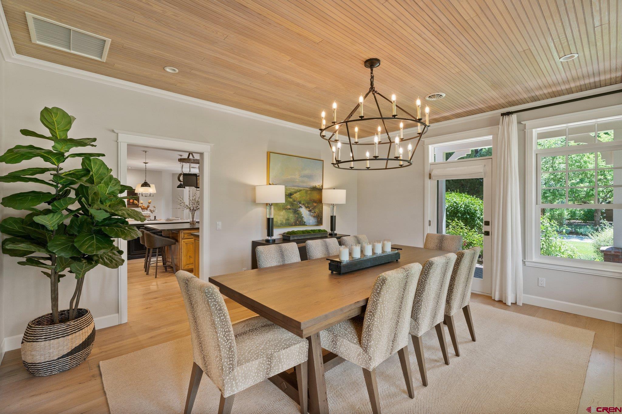 385 Red Rock Road Durango, CO 81301 - Photo 5 of 35 a view of a dining room with furniture a chandelier and large window