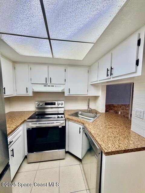 1609 Sunny Brook Lane, Unit E201 Palm Bay, FL 32905 - Photo 3 of 15 a kitchen with a stove sink and cabinets
