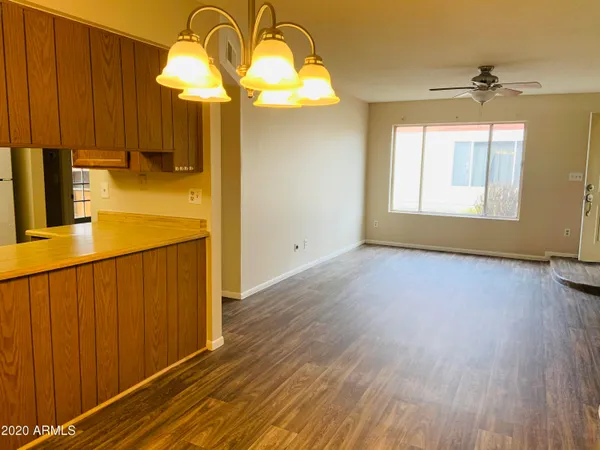 a view of a room with wooden floor and windows