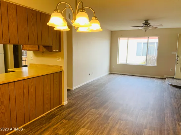 a view of a room with wooden floor and windows