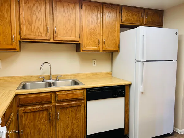 a kitchen with stainless steel appliances granite countertop a refrigerator sink and cabinets