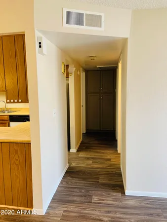 a view of a hallway with wooden floor