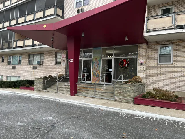 a view of a house with a patio and a yard