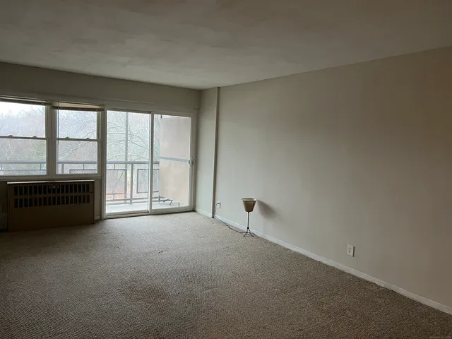 an empty room with large windows