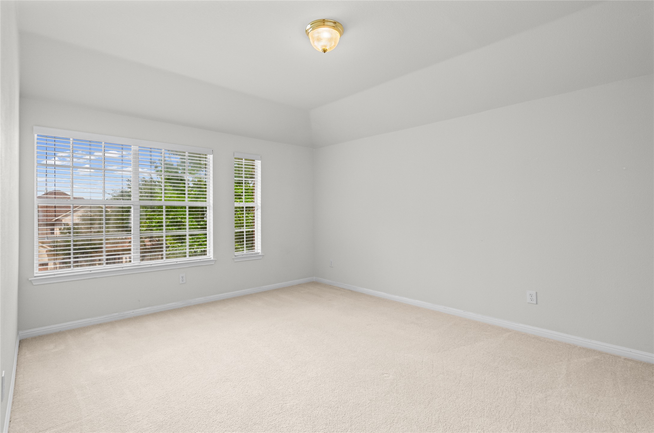 10700 Pointe View Drive Austin, TX 78738 - Photo 26 of 35 A quiet retreat, this bedroom offers ample natural light through multiple windows, complemented by soft carpeting.