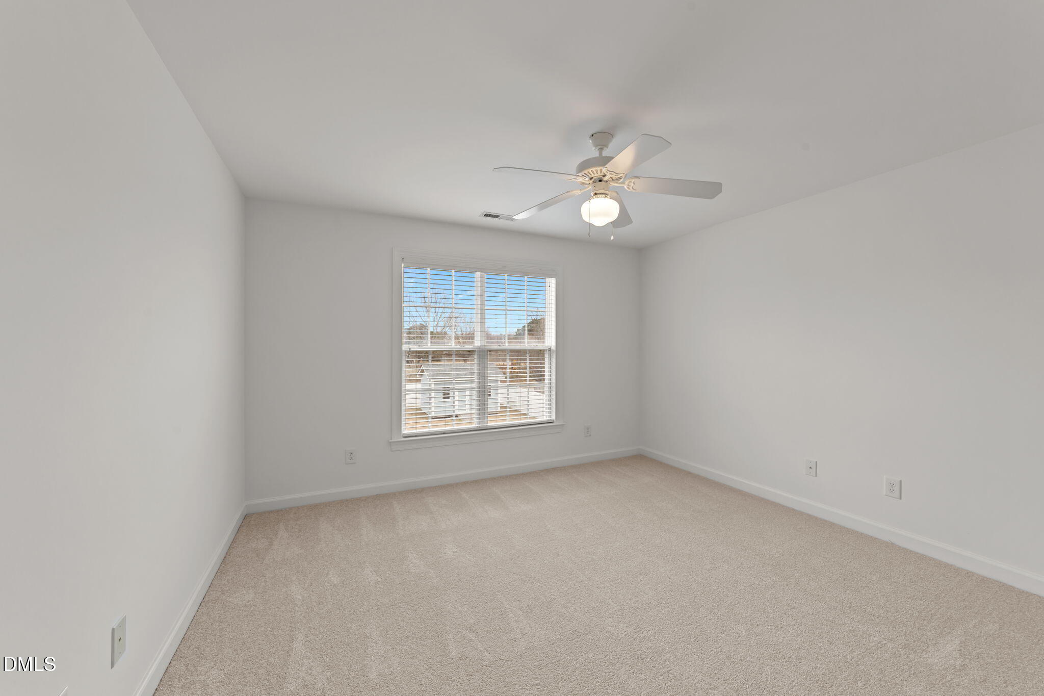 7101 Numa Circle Willow Spring, NC 27592 - Photo 22 of 44 an empty room with a window and a fan