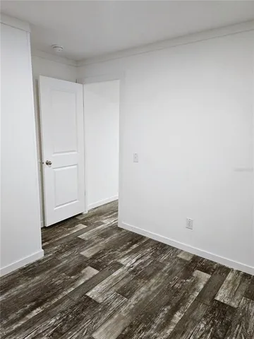 a view of a room with wooden floor