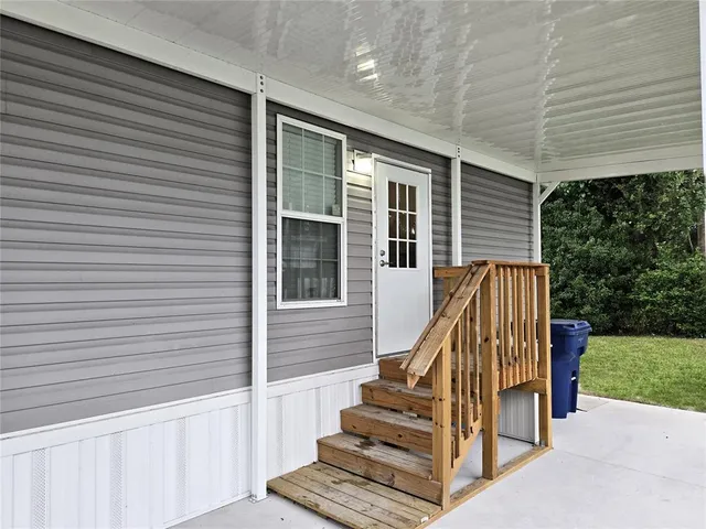a view of a patio with table and chairs with wooden fence