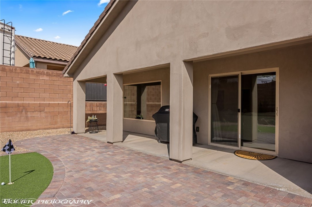 942 Shadow Hawk Ridge Mesquite, NV 89027 - Photo 49 of 67 View of patio with an area to practice putting, fence, and area for grilling