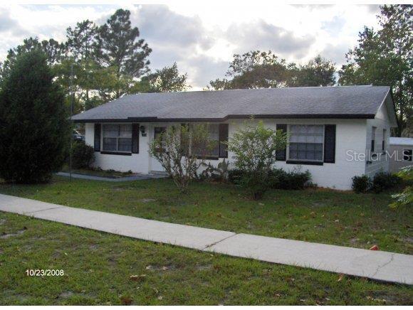 3430 Southwest 150th Lane Road Ocala, FL 34473 - Photo 1 of 1 a front view of a house with garden