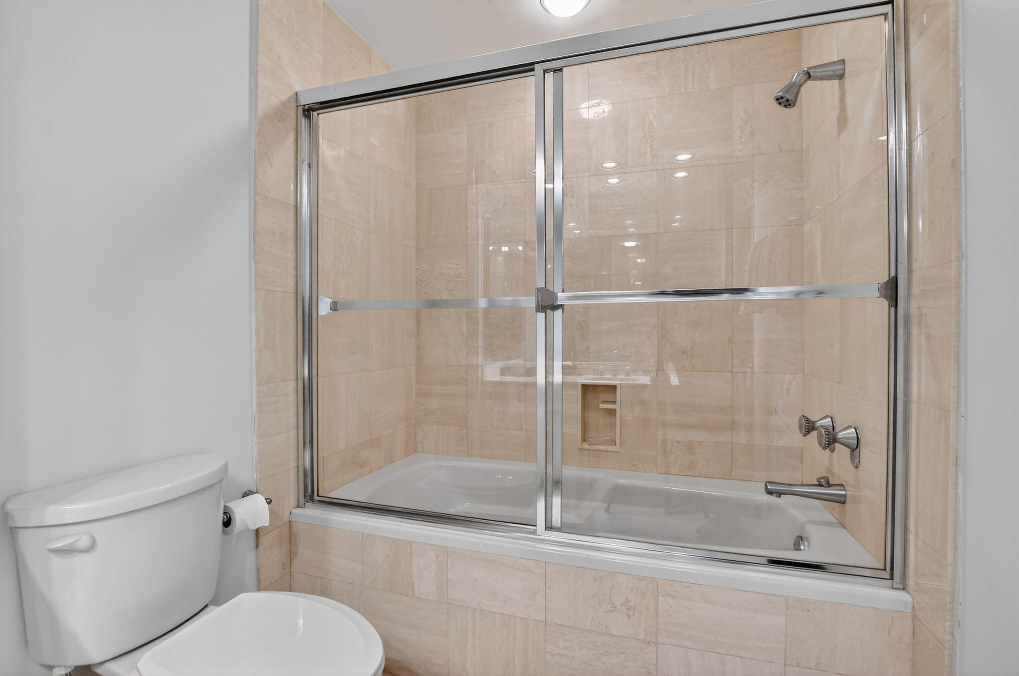 20310 Fairway Oaks Drive, Unit 124 Boca Raton, FL 33434 - Photo 21 of 65 a bathroom with a shower a toilet and a glass door shower