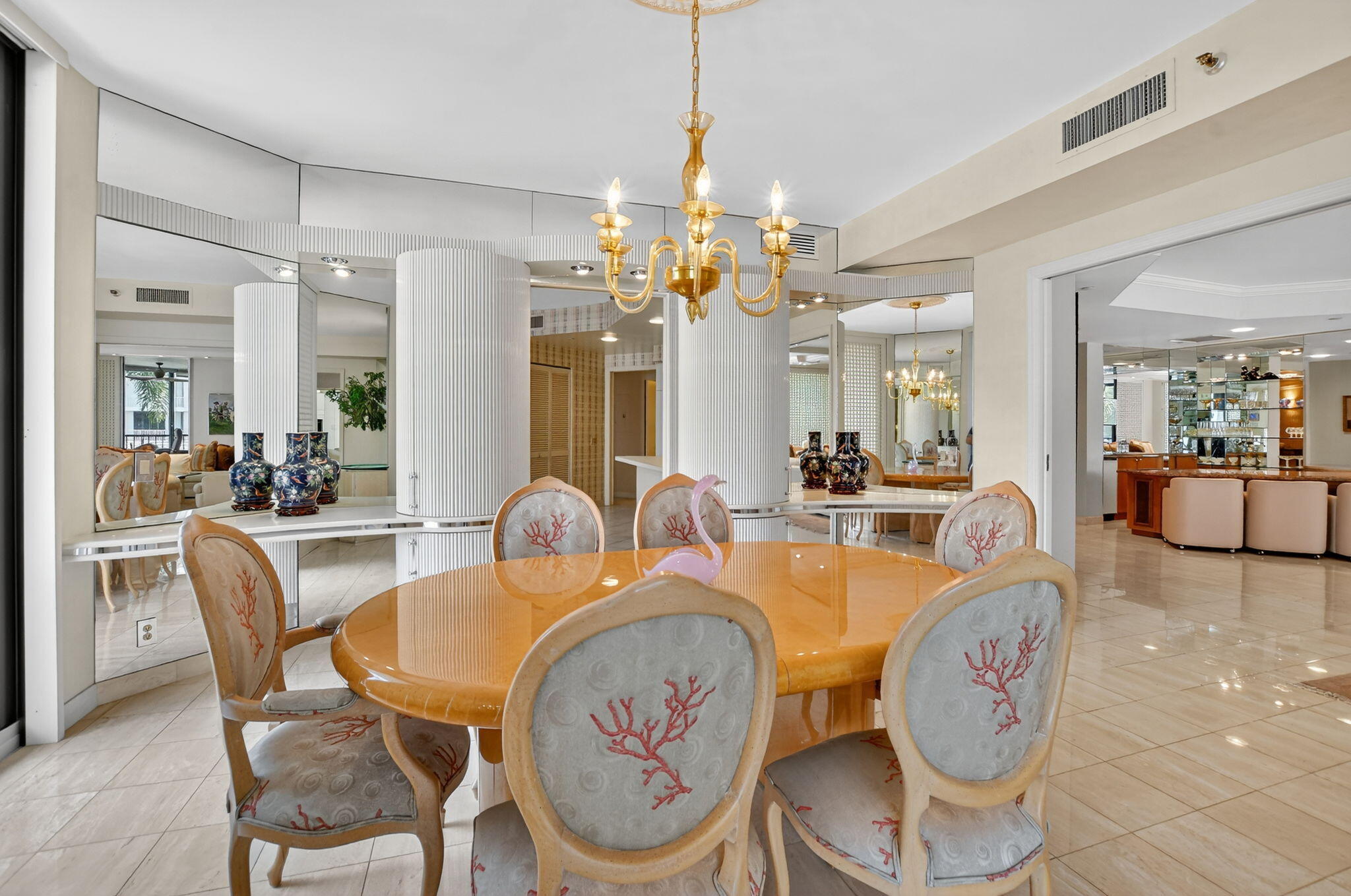 20310 Fairway Oaks Drive, Unit 124 Boca Raton, FL 33434 - Photo 41 of 65 a dining room with furniture a chandelier and wooden floor
