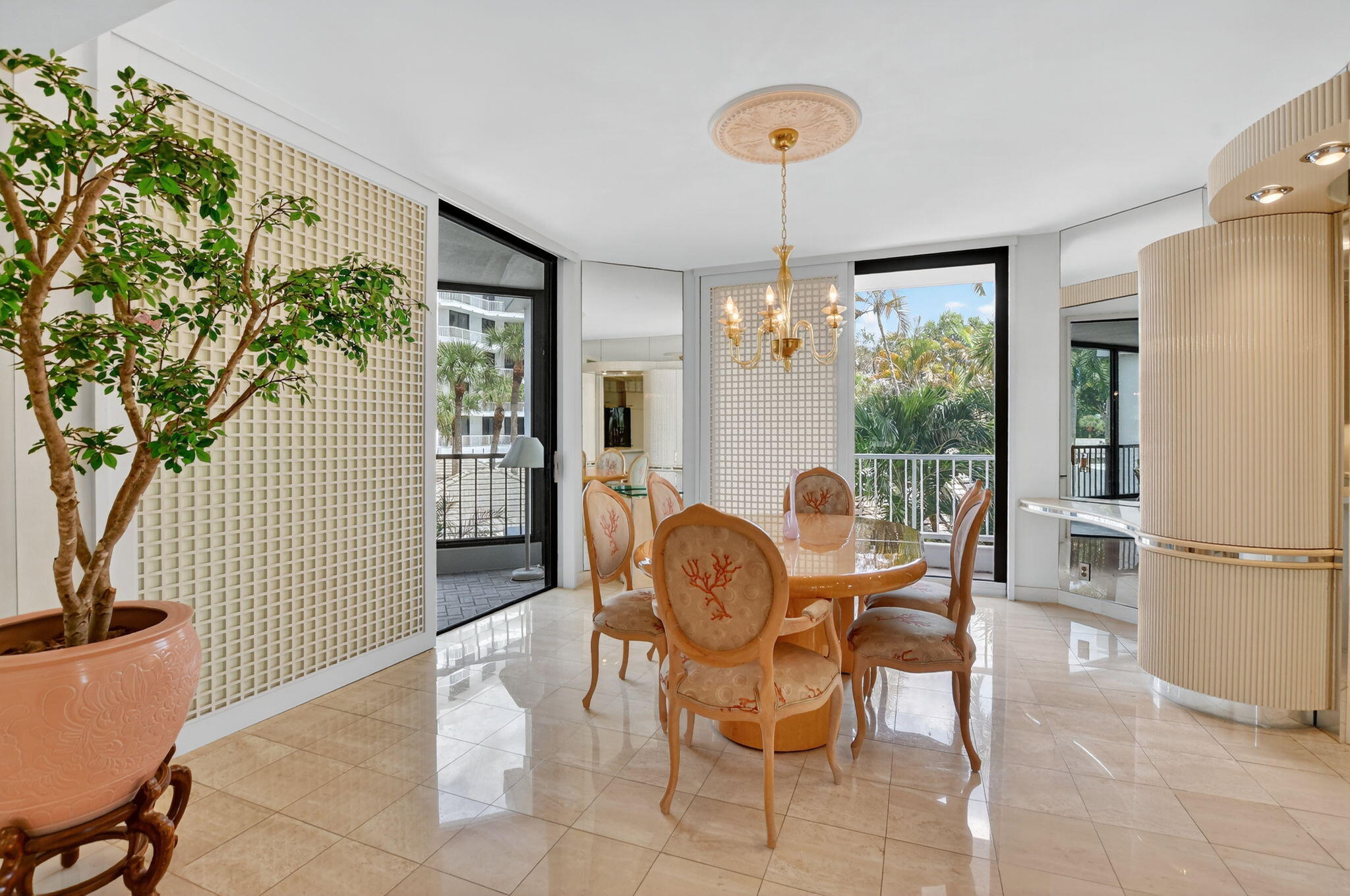 20310 Fairway Oaks Drive, Unit 124 Boca Raton, FL 33434 - Photo 42 of 65 a dining room with furniture a chandelier and wooden floor