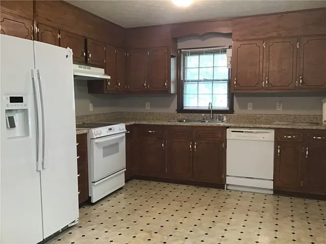 a kitchen with a sink a stove and refrigerator