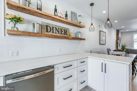 a kitchen with kitchen island stainless steel appliances a sink and cabinets