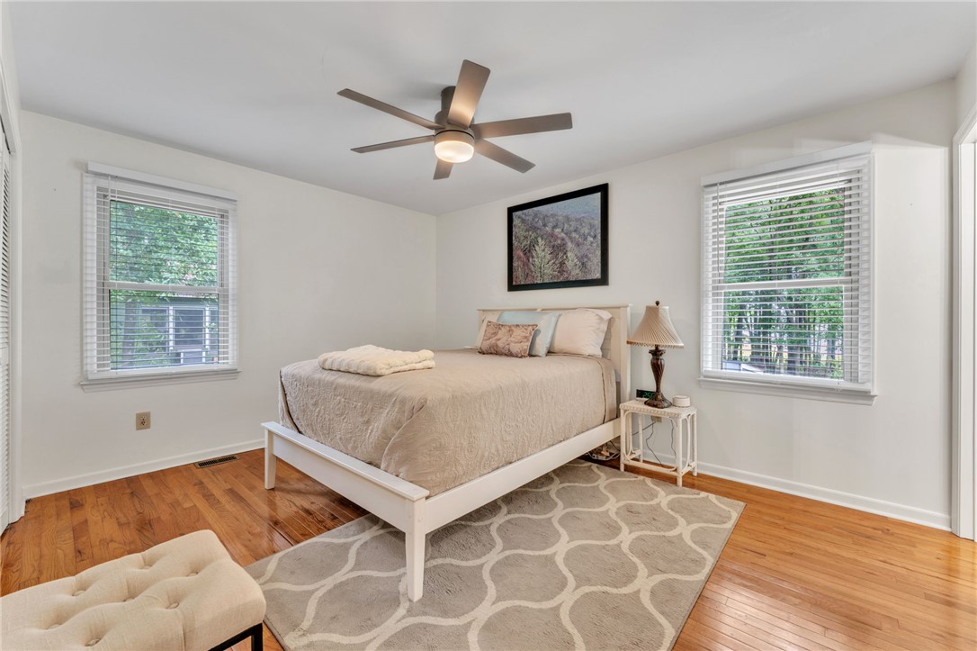 4416 Denver Cove Road Anderson, SC 29625 - Photo 15 of 31 Hardwood floors and a ceiling fan enhance this cozy bedroom, creating a comfortable and inviting atmosphere.