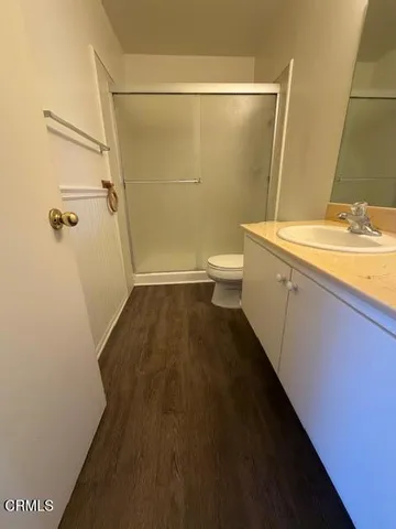 a bathroom with a granite countertop sink toilet and shower