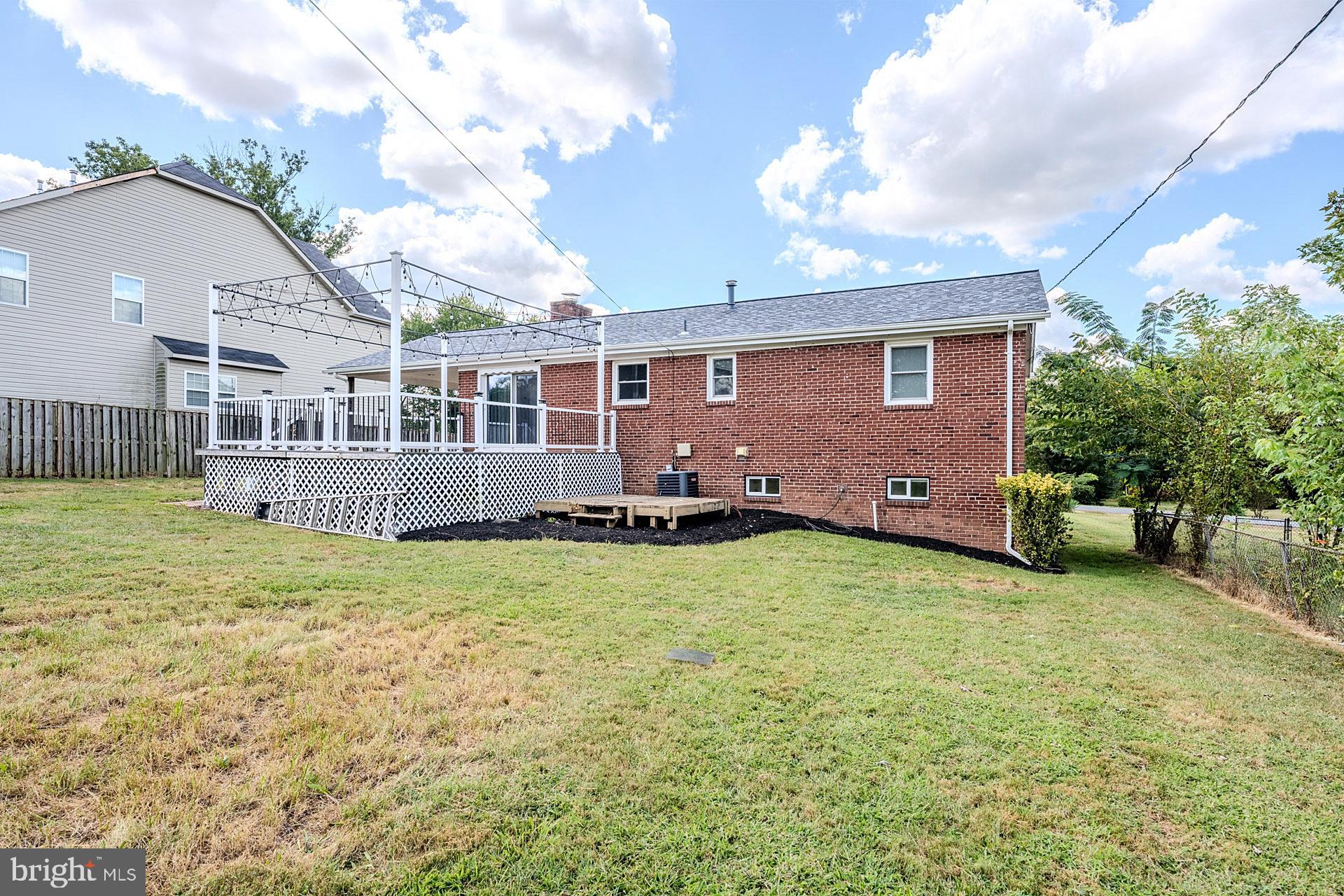 7625 Huron Drive Gainesville, VA 20155 - Photo 33 of 34 a view of a house with a backyard and a tree