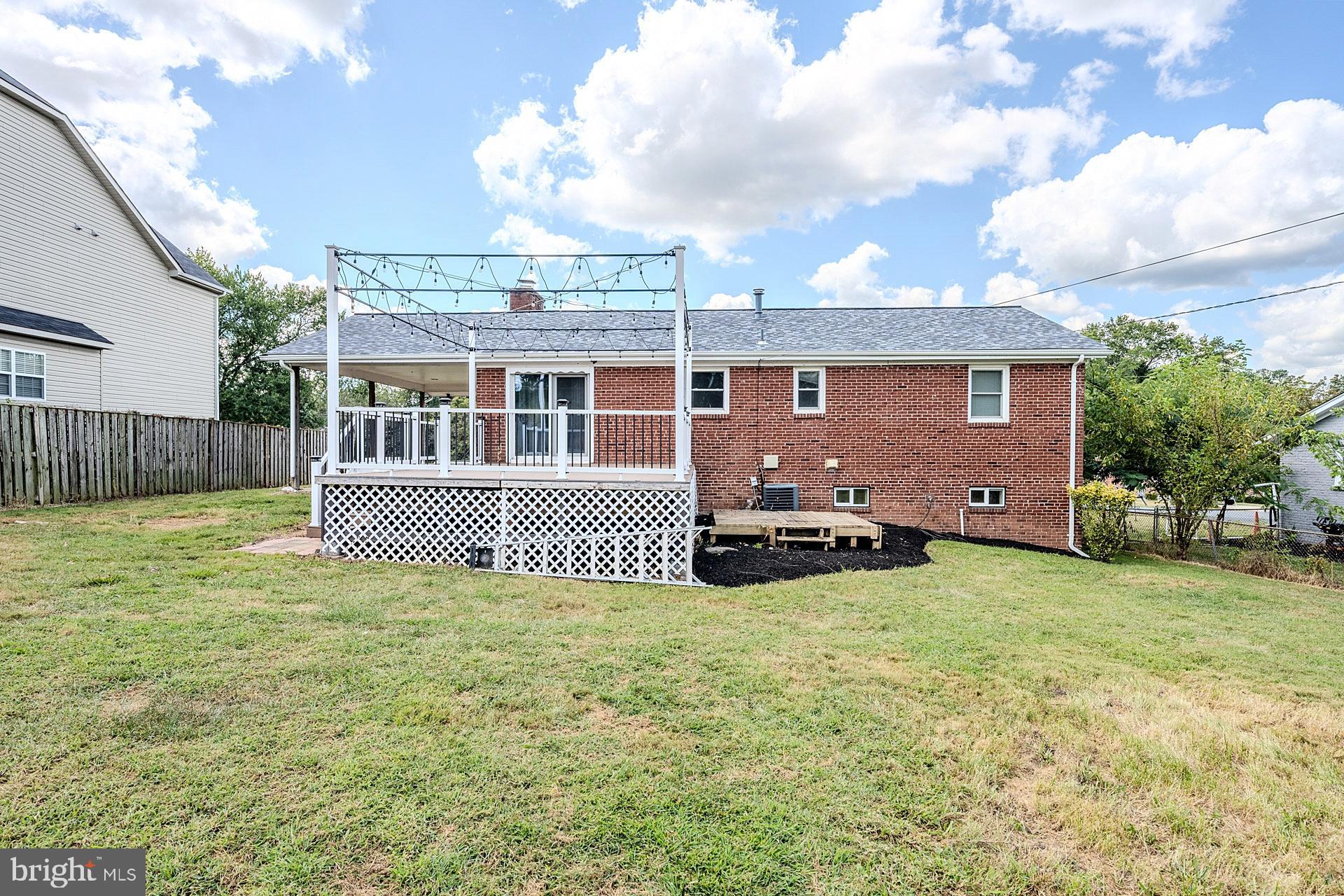 7625 Huron Drive Gainesville, VA 20155 - Photo 34 of 34 a view of a house with a patio and a yard
