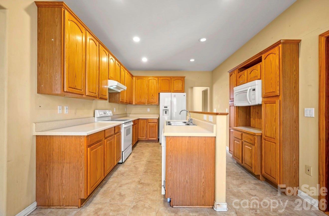 523 Shepherds Creek Circle Rutherfordton, NC 28139 - Photo 14 of 31 a kitchen with stainless steel appliances granite countertop a stove a sink dishwasher and a refrigerator