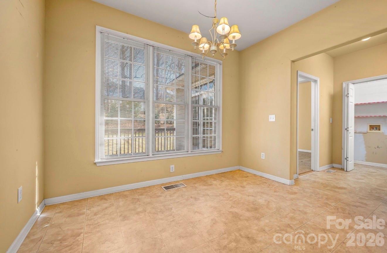 523 Shepherds Creek Circle Rutherfordton, NC 28139 - Photo 16 of 31 an empty room with chandelier fan and windows