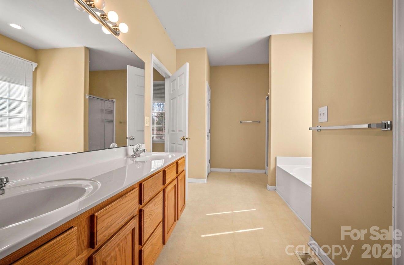 523 Shepherds Creek Circle Rutherfordton, NC 28139 - Photo 22 of 31 a bathroom with a granite countertop sink a mirror and a bathtub
