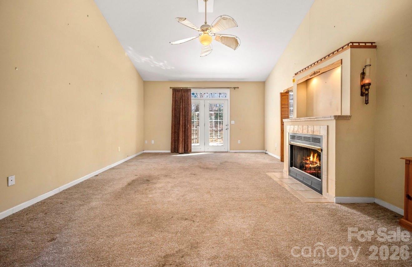 523 Shepherds Creek Circle Rutherfordton, NC 28139 - Photo 10 of 31 a view of a livingroom with a fireplace a chandelier fan and windows