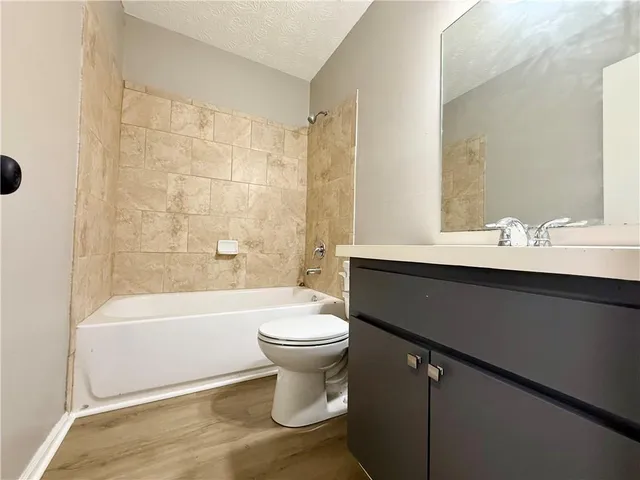 a bathroom with a sink a toilet and a bathtub