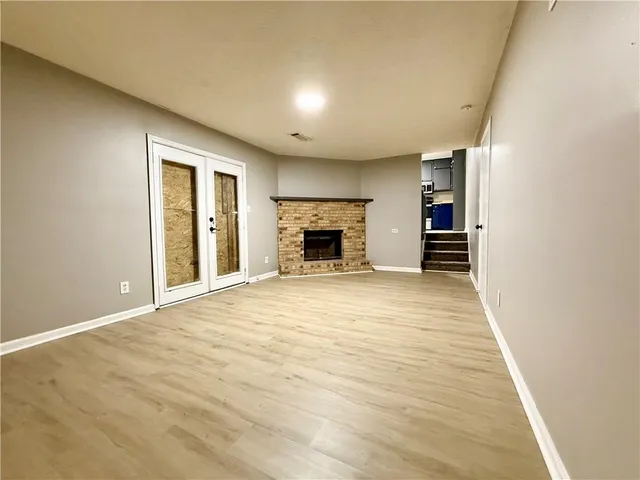 wooden floor in an empty room with a fireplace