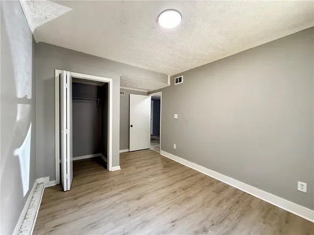 a room with a wooden floor and window