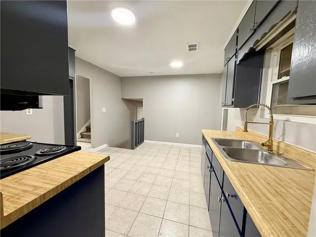 a kitchen with a sink and a stove top oven