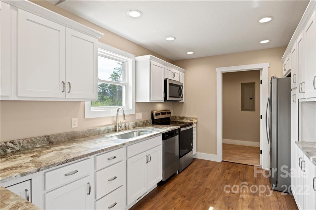 53 Sharptown Road Canton, NC 28716 - Photo 13 of 34 a kitchen with granite countertop white cabinets and appliances