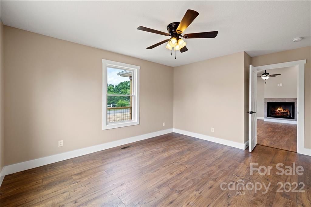 53 Sharptown Road Canton, NC 28716 - Photo 17 of 34 a view of a livingroom with a ceiling fan and wooden floor
