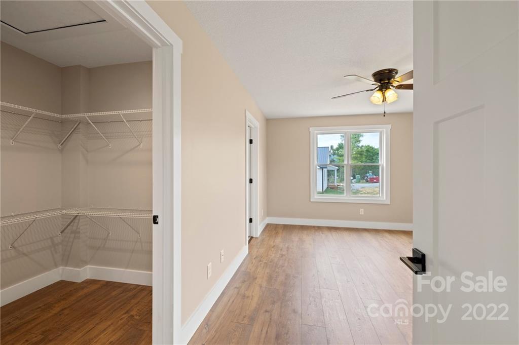 53 Sharptown Road Canton, NC 28716 - Photo 20 of 34 a view of a hallway with wooden floor and a bathroom