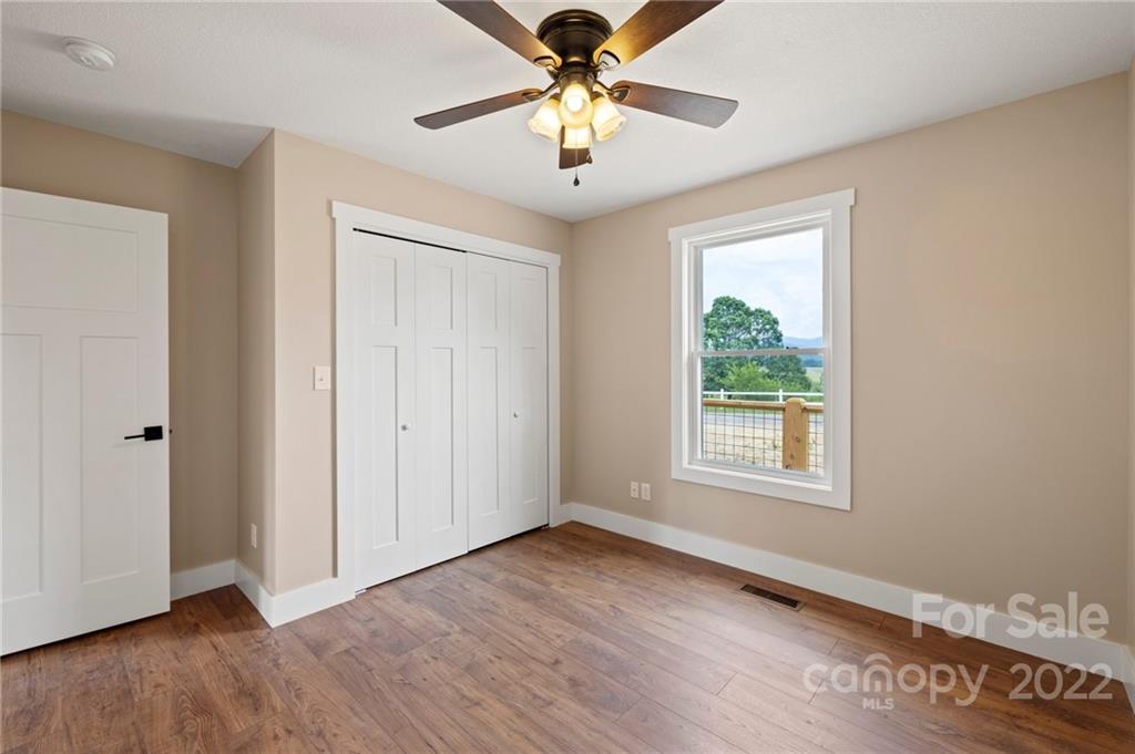 53 Sharptown Road Canton, NC 28716 - Photo 25 of 34 a view of an empty room with window and wooden floor