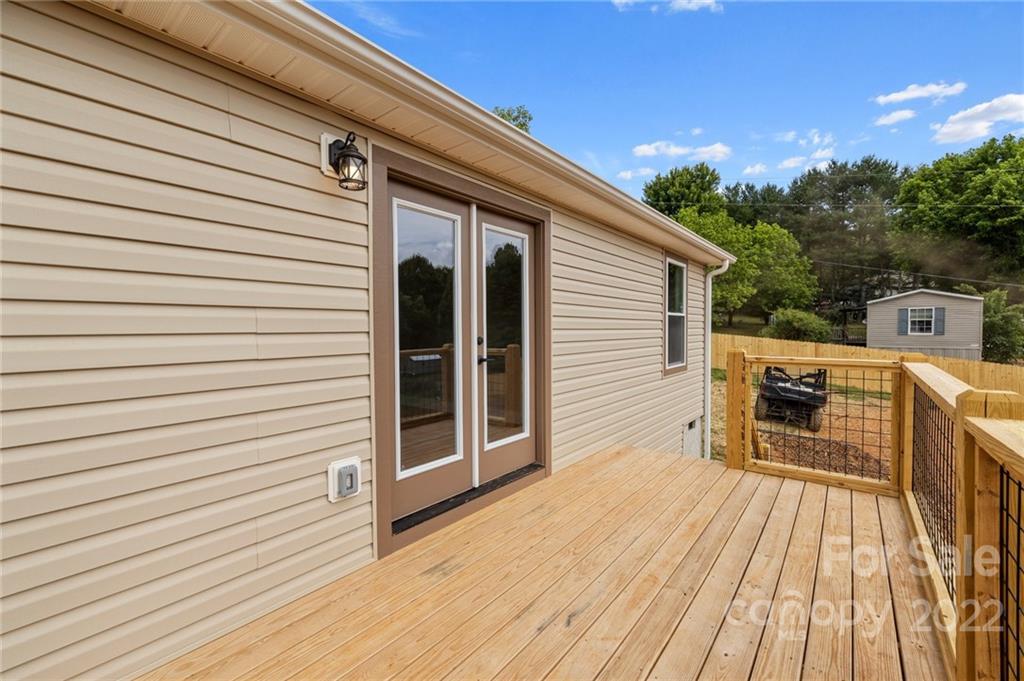 53 Sharptown Road Canton, NC 28716 - Photo 32 of 34 a view of a patio with table and chairs with wooden floor and fence