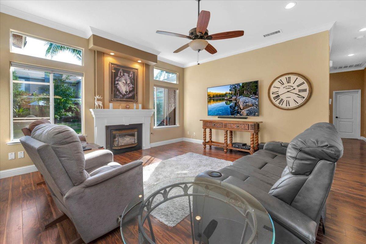 2474 Twain Avenue Clovis, CA 93611 - Photo 12 of 55 a living room with furniture a fireplace and a large window
